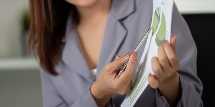 A professional shows a data report, emphasizing the results on charts, facilitating a deeper understanding of business trends among peers.