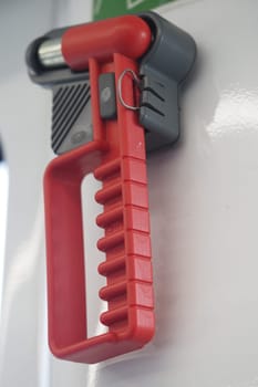 A red utility handle provides stability for passengers on a train.