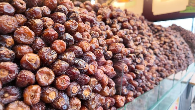 Vendors display an array of dried dates for sale at a market.