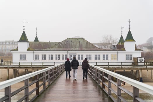 Ahlbeck, Germany - December 27, 2024: View over the pier of Ahlbeck with some tourists on the German Baltic Sea coast in Winter