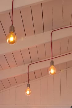 Soft warm light emanates from vintage bulbs suspended from the ceiling.