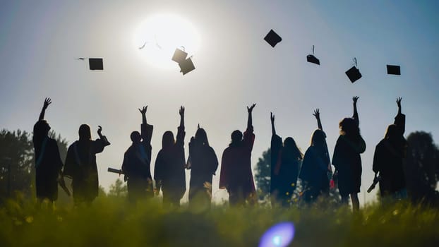 Graduates celebrating their accomplishment by throwing their caps in the air on a sunny day