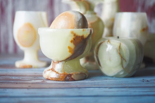 Beautifully crafted onyx cups and decorative pieces on a wooden surface.