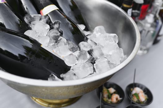 Champagne Bottles on Ice cubes at a French Wedding