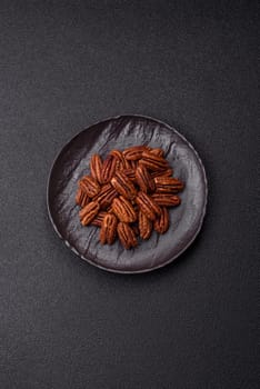 Nut, pecans in a ceramic bowl, an ingredient in vegan food. Nuts as a source of nutrients