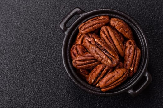 Nut, pecans in a ceramic bowl, an ingredient in vegan food. Nuts as a source of nutrients