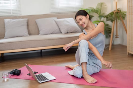 Enjoying a calming routine, a woman incorporates various yoga stretches, enhancing her mobility and mental clarity in a cozy setting.