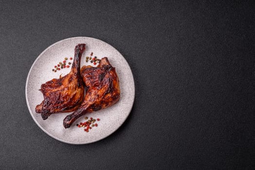 Duck, chicken leg or thigh grilled on a dark concrete background. Duck confit, Asian food with salt and spices