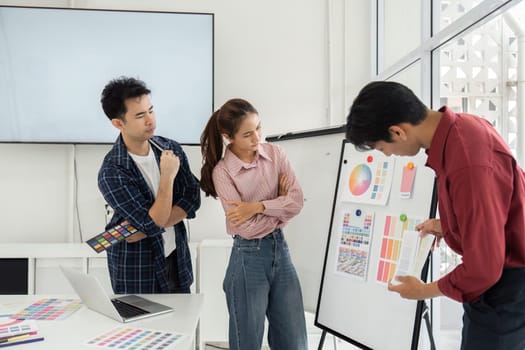 Creative professionals engage in a vibrant discussion about color options, reflecting on the mood and impact of their choices.