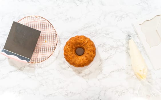 The freshly baked Carrot Bundt Cake is beautifully frosted with a luscious layer of cream cheese frosting.