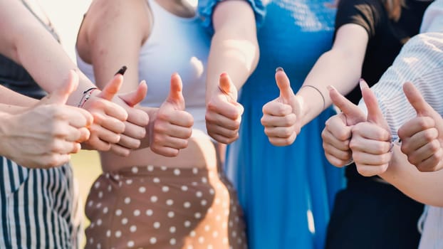 Group of students giving thumbs up, celebrating teamwork, agreement, and shared success, radiating positivity and confidence together