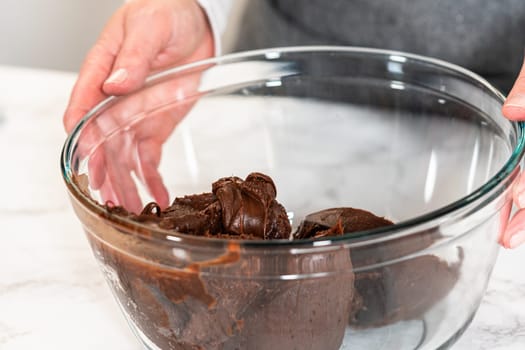 The frosting is whipped to perfection before being piped onto the delicious chocolate cupcakes.