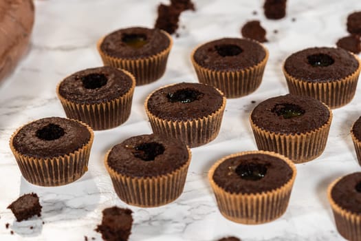 Each chocolate cupcake receives a generous filling of luscious caramel, adding an extra layer of flavor and indulgence.