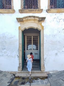 Paraty, Rio de Janeiro, Brazil, February 6, 2025, tourist couple entering the colonial portal of the Church of Santa Rita.
