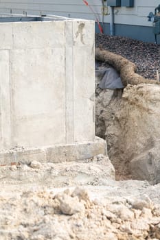 An ongoing construction site in the suburbs, featuring the foundation stage of a single-family house.