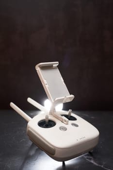 DJI Phantom Professional drone remote control stands on a black table. High quality photo