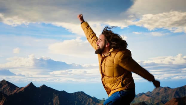Clumsy adventurer finds himself at the mercy of the wind struggling to keep balance, falling off of a mountain top. The cold weather proves unforgiving for unprepared hiker. Camera B.