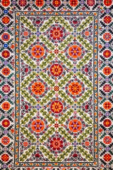 traditional Uzbek geometric pattern on an ancient handmade carpet in Uzbekistan. Oriental background with beautiful ornaments