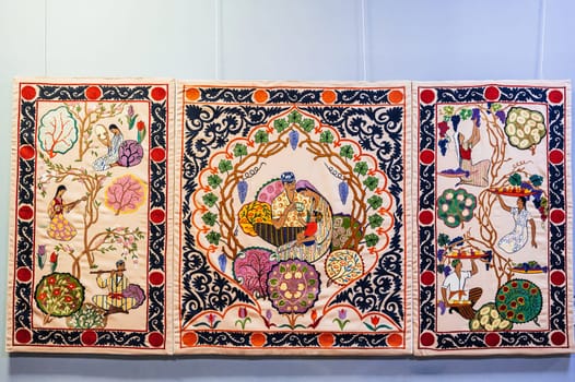 oriental Uzbek carpets with a traditional pattern. Vintage Asian handmade embroidered carpets on the wall in Uzbekistan