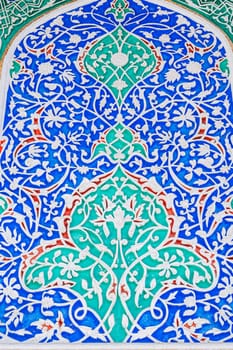 beautiful background of carved wooden painted wall in the Museum of Art of Uzbekistan with Uzbek ornaments and colorful oriental patterns in Tashkent