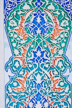 carved wooden painted background in Museum of Art of Uzbekistan with traditional Uzbek ornaments and colorful oriental patterns in Tashkent