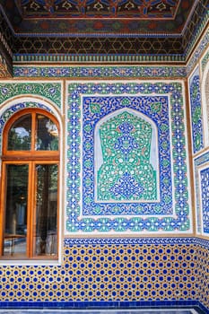 beautiful art carved wooden painted wall in the Museum of Art of Uzbekistan with traditional Uzbek ornaments and colorful oriental patterns in Tashkent
