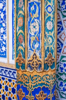 beautiful carved wooden painted column and wall in Museum of Art of Uzbekistan with traditional Uzbek ornaments and colorful oriental patterns in Tashkent