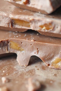 Close-up of chocolate bark featuring fruit pieces on a countertop.