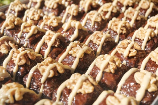 Delicious turkish baklava decorated with creamy topping and nuts,