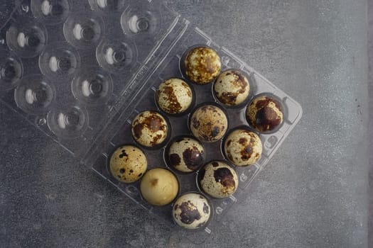 Twelve quail eggs in a clear carton, ready for meals.