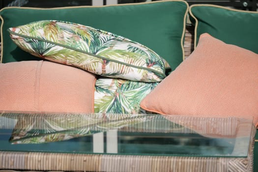 Relaxation area featuring colorful cushions and a glass tabletop.