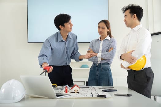 The team engages in dynamic discussions, showcasing their expertise in design and construction. They celebrate the synergy of engineering and architecture.