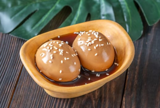 Soft-boiled ramen eggs soaked in savory marinade, garnished with sesame seeds