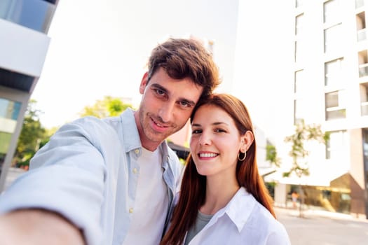 man and woman smiling happy for a selfie picture, they are cheerful looking at camera and enjoying the moment, concept of modern couple and urban lifestyle