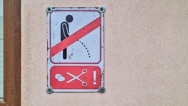 No Urination notice. No Urinating sign. No Peeing in Public sign. Urinating person and scissors on signs.