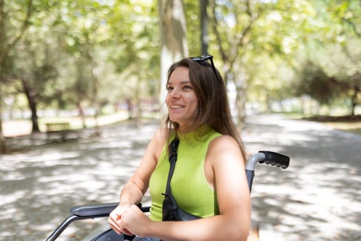 Happy disabled woman enjoying freedom and mobility in a natural park setting, embracing a positive and fulfilling life