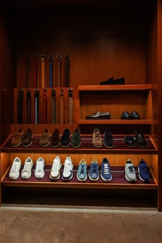 Elegant men's leather shoes on store shelves in mall. Shopping center. Men's clothing store. Accessories for Man. Fashion and style.