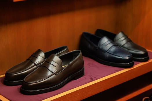 Elegant men's leather shoes on store shelves in mall. Shopping center. Men's clothing store. Accessories for Man. Fashion and style.