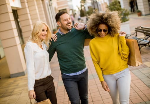 Group of young multiracial friends shopping in mall together