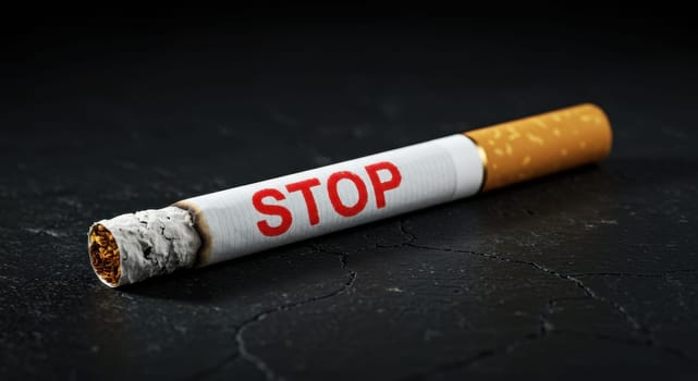 Close up of a burning cigarette with a red STOP text on it, placed on a dark, cracked surface. Concept for quitting smoking, addiction, and health.