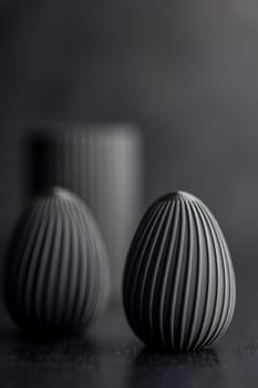Easter decoration. Black eggs on a black background.