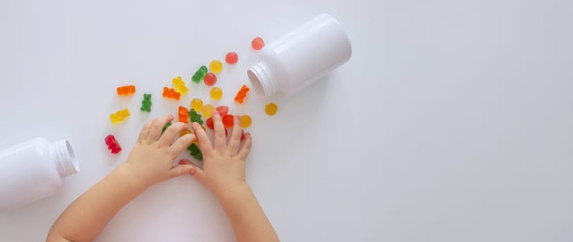 close-up of a little girl's hand taking jelly beans or vitamins