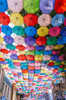 Multicolored bright colorful umbrellas decoration street on Magic City Park in Tashkent. Tashkent, Uzbekistan - June 15, 2024