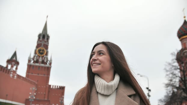 A young tourist woman admires the view of the center of Moscow and the river. Travel in Russia