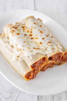 Delicate cannelloni pasta, generously filled with rich bolognese sauce, baked under a blanket of melted mozzarella