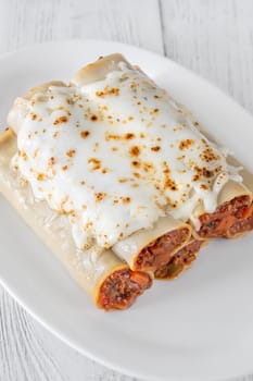 Delicate cannelloni pasta, generously filled with rich bolognese sauce, baked under a blanket of melted mozzarella