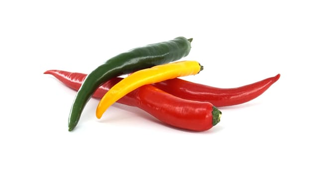 Red, green and yellow chili peppers are creating a colorful and vibrant composition on a clean white background, ideal for food photography or culinary projects