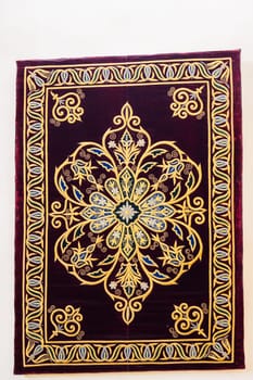 oriental Uzbek asian carpet with a traditional geometric pattern. Vintage luxury handmade Turkish carpet on white isolated background