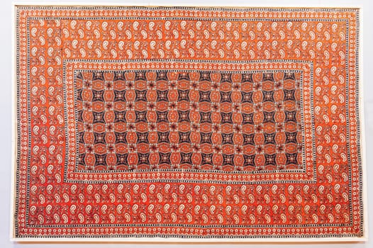 oriental Uzbek carpet with a traditional abstract geometric pattern. Vintage handmade Turkish carpet on a white isolated background