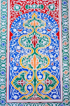 colorful carved wooden painted background with traditional Uzbek ornaments and oriental asian patterns in Tashkent in Uzbekistan